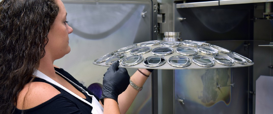 picture of lab tech at AR coating machine